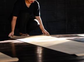 Yoga instructor preparing mat